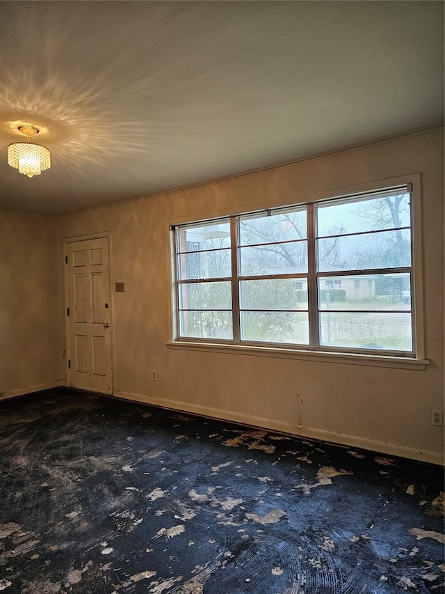 foyer entrance featuring dark colored carpet and baseboards