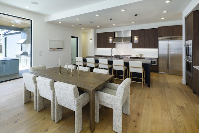 dining space featuring recessed lighting and light wood finished floors