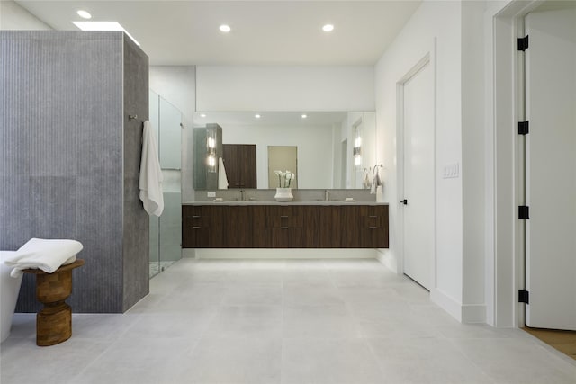 full bath featuring double vanity, walk in shower, a sink, and recessed lighting