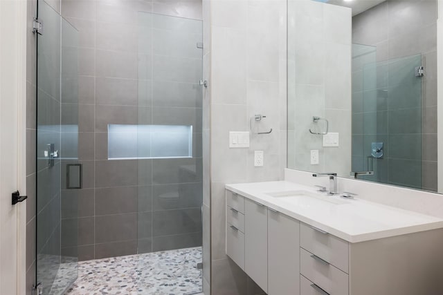 full bathroom with a shower stall and vanity