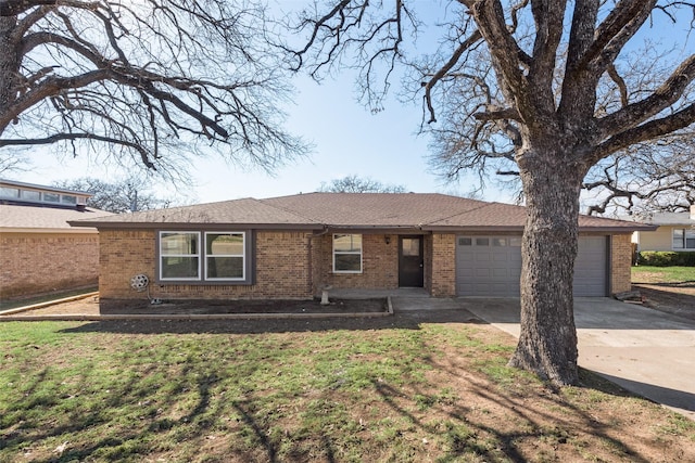 ranch-style house with an attached garage, a front lawn, concrete driveway, and brick siding