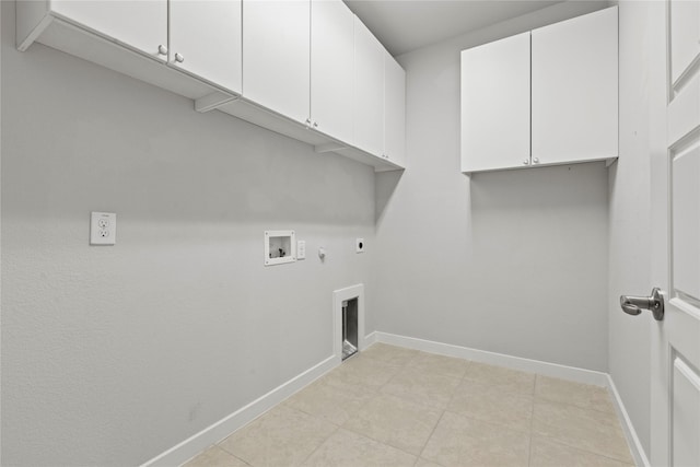 clothes washing area with cabinet space, baseboards, gas dryer hookup, hookup for a washing machine, and hookup for an electric dryer