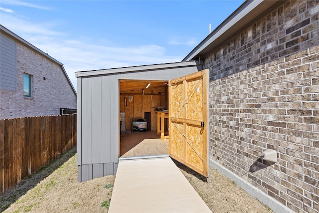 view of shed featuring fence