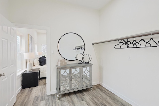 interior space featuring baseboards and wood finished floors