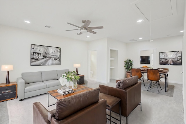 living room with attic access, recessed lighting, visible vents, and built in features