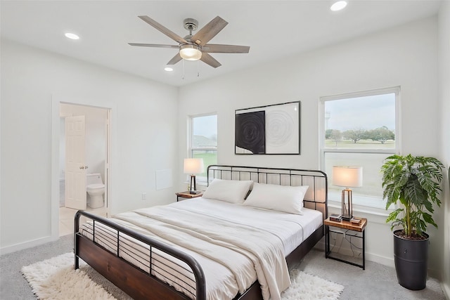 bedroom featuring light carpet, baseboards, and recessed lighting