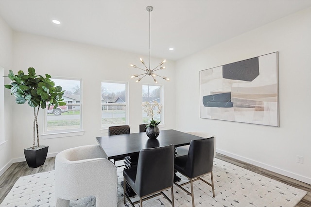 dining space with baseboards, plenty of natural light, wood finished floors, and recessed lighting