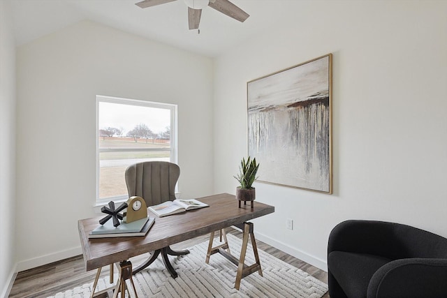 office space featuring light wood-style floors, ceiling fan, and baseboards