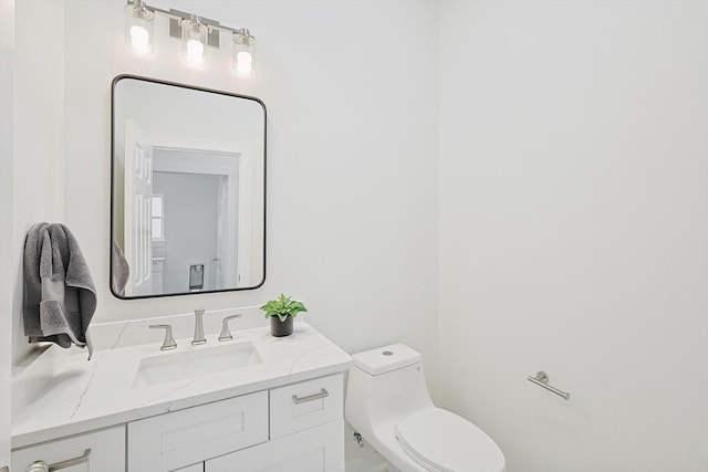 half bathroom with toilet and vanity