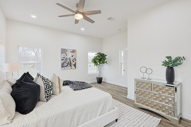 bedroom featuring baseboards, visible vents, ceiling fan, wood finished floors, and recessed lighting