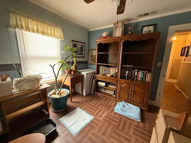 office area with crown molding, visible vents, and a ceiling fan