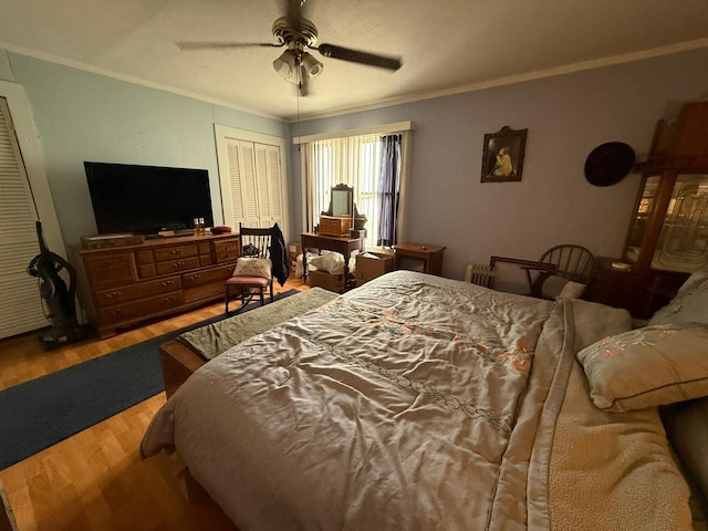 bedroom featuring ceiling fan, crown molding, and wood finished floors