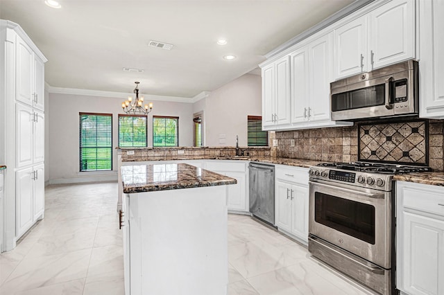 kitchen with appliances with stainless steel finishes, marble finish floor, visible vents, and white cabinetry