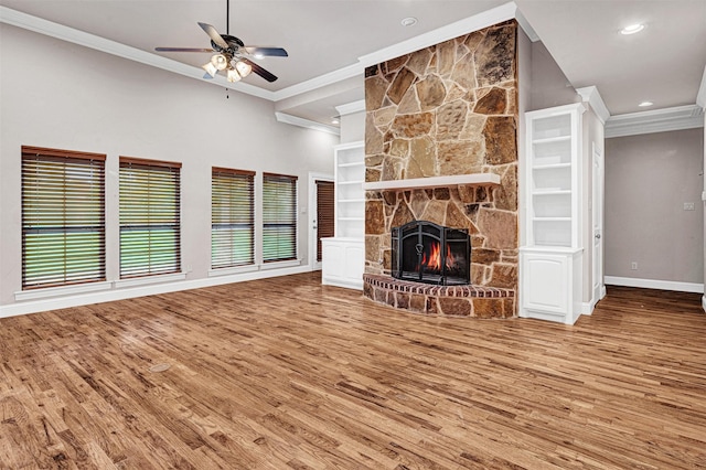 unfurnished living room with a fireplace, wood finished floors, and crown molding