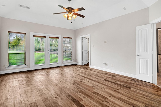 spare room featuring visible vents, ceiling fan, baseboards, and wood finished floors