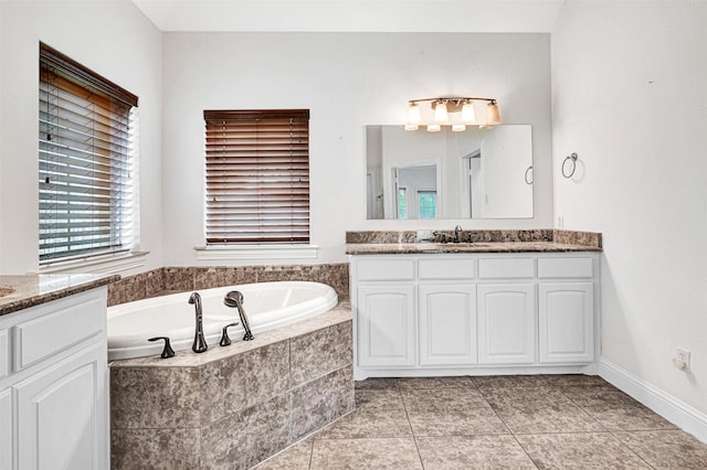 full bath with a garden tub, tile patterned floors, and vanity