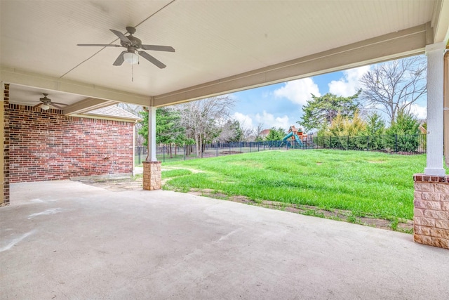 view of patio with ceiling fan, a playground, and a fenced backyard