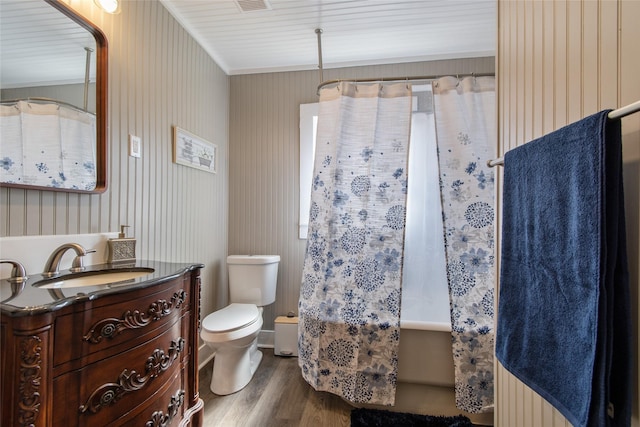 bathroom with shower / bath combo, vanity, toilet, and wood finished floors