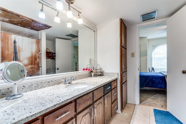 full bath with tile patterned flooring, visible vents, vanity, and ensuite bath