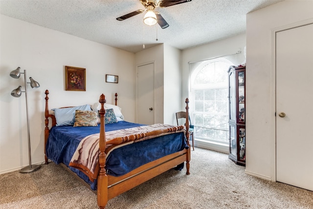 bedroom featuring carpet floors, multiple windows, and a textured ceiling