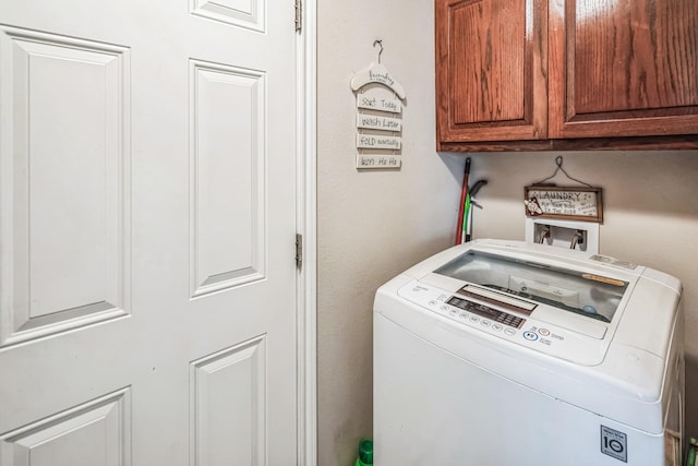 clothes washing area featuring cabinet space and washer hookup