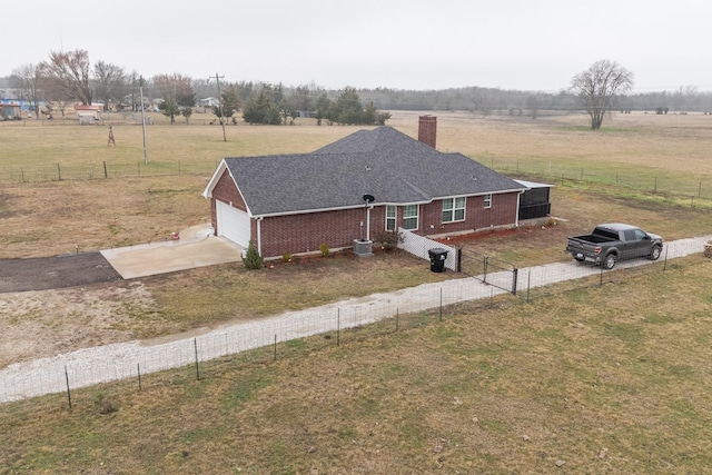 birds eye view of property with a rural view