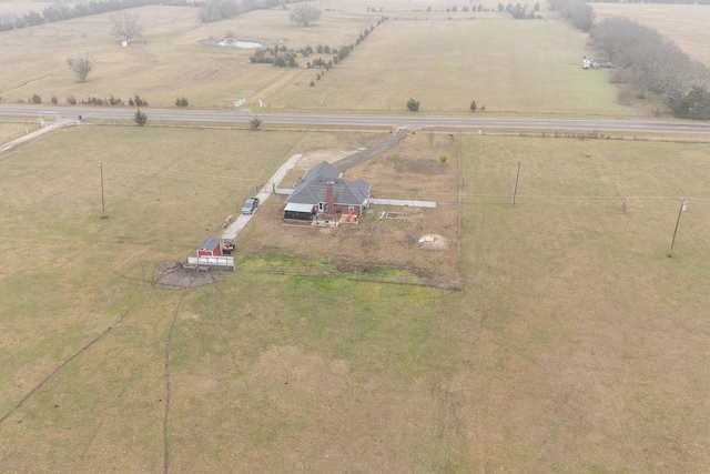 birds eye view of property with a rural view