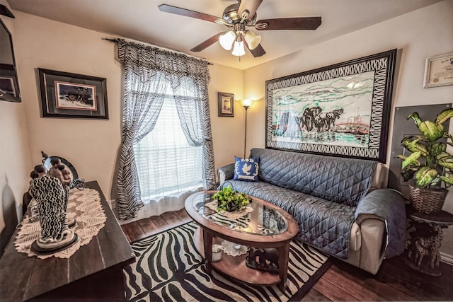 living area with wood finished floors and a ceiling fan