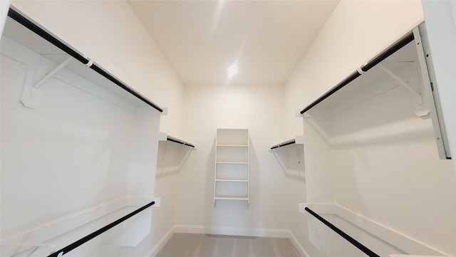 walk in closet featuring a barn door