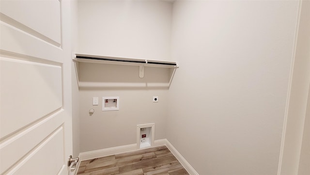 washroom with hookup for a washing machine, light wood-style flooring, gas dryer hookup, electric dryer hookup, and laundry area