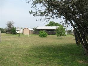 view of yard with an outbuilding and a storage unit