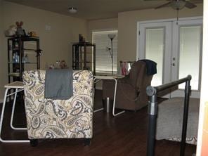 living room featuring dark wood-style floors and a ceiling fan