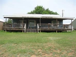 rear view of property with a lawn and a wooden deck