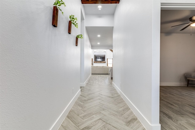 corridor with parquet flooring and baseboards