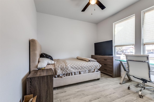 bedroom featuring light wood-style flooring and ceiling fan