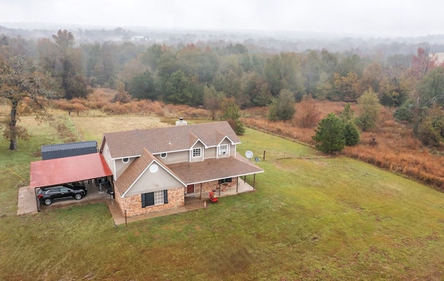 drone / aerial view featuring a view of trees