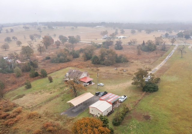 birds eye view of property with a rural view