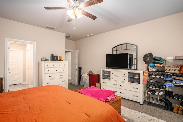 bedroom featuring a ceiling fan, light colored carpet, and visible vents