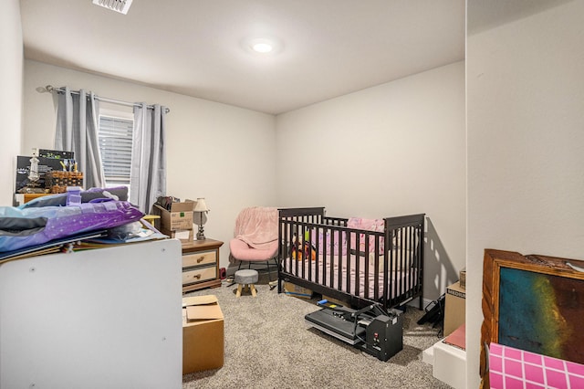 carpeted bedroom featuring visible vents