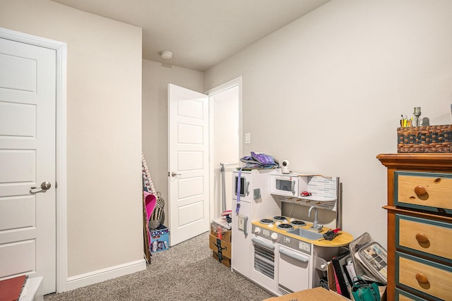 recreation room with carpet floors and baseboards