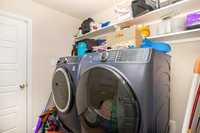 clothes washing area featuring laundry area and separate washer and dryer