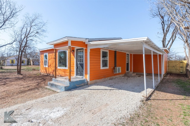 view of front facade featuring a carport and gravel driveway