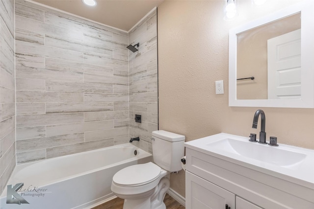 full bathroom with shower / washtub combination, a textured wall, toilet, vanity, and wood finished floors