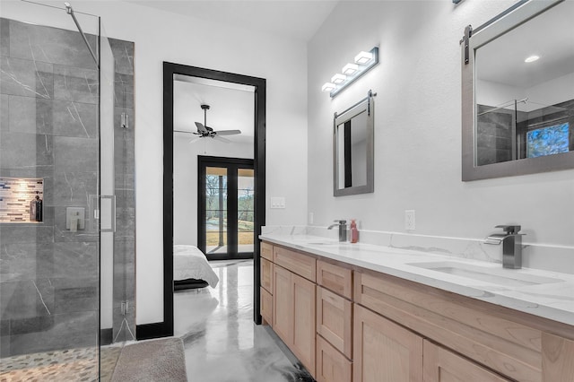 ensuite bathroom featuring french doors, a sink, ensuite bath, and double vanity