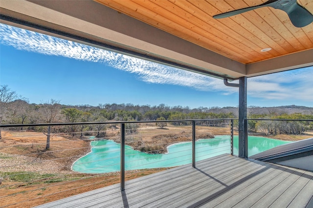 balcony featuring a wooded view