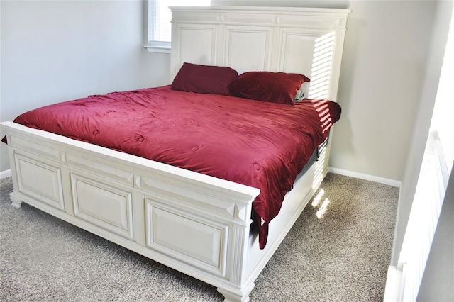 bedroom with light carpet and baseboards