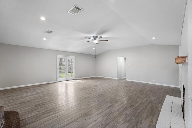 unfurnished living room with wood finished floors, a fireplace, visible vents, and french doors