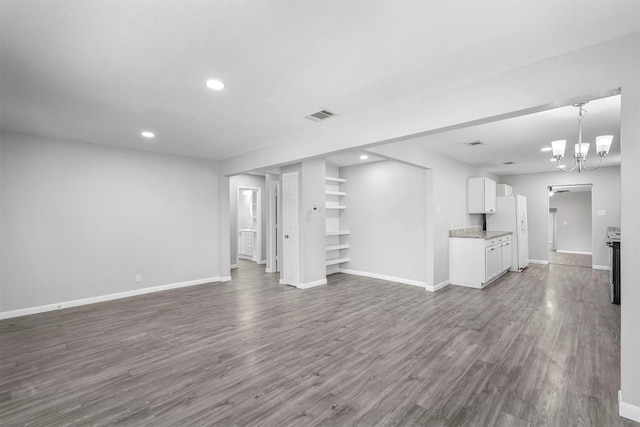 unfurnished living room featuring recessed lighting, baseboards, and dark wood-style flooring