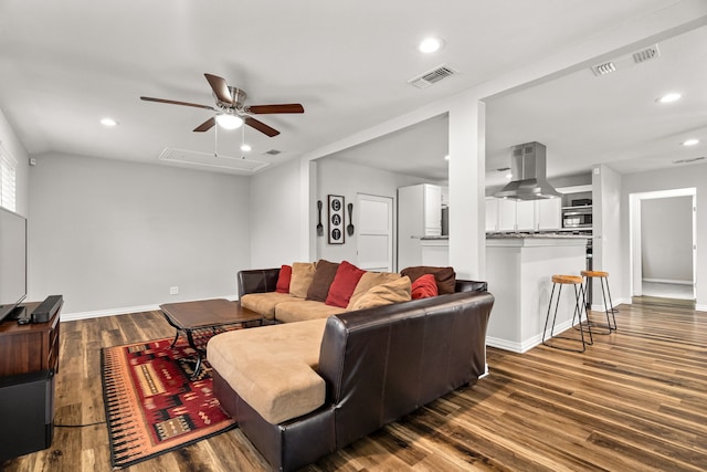 living room with recessed lighting, visible vents, dark wood finished floors, and baseboards