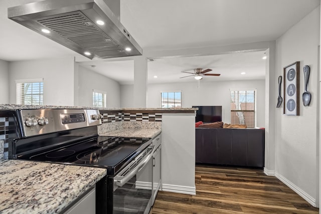 kitchen with a wealth of natural light, open floor plan, island exhaust hood, and electric range